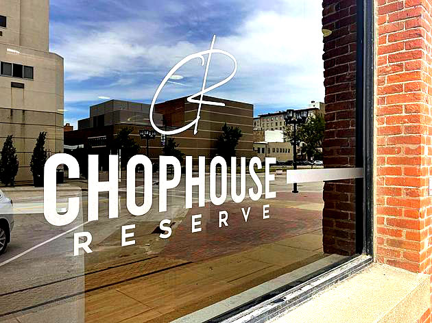 Event venue in downtown cedar rapids. Chophouse reserve logo on a glass window with Downtown in the reflection